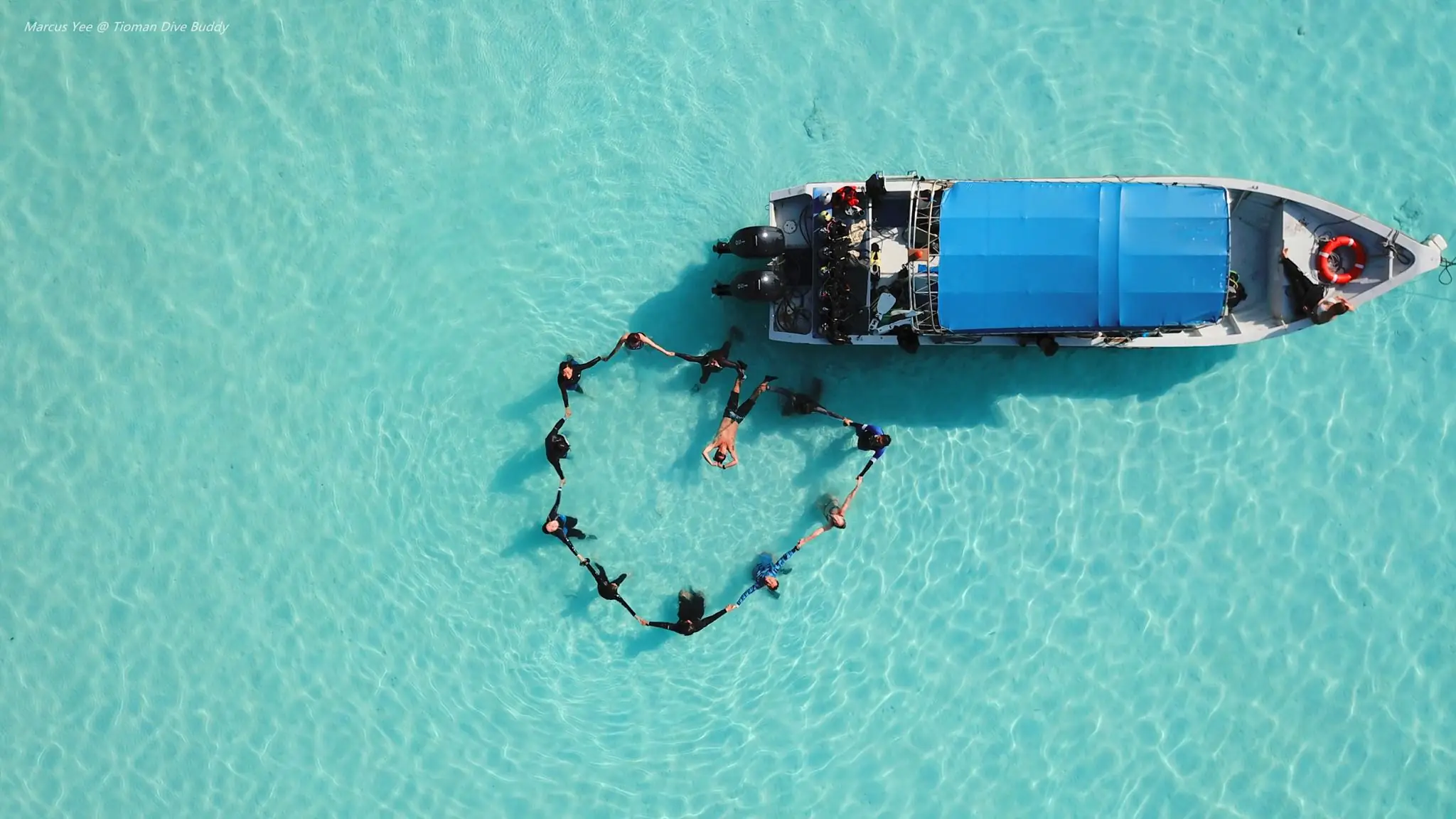 Aerial Serenity Divers in Harmony Amidst Tioman's Pristine Waters