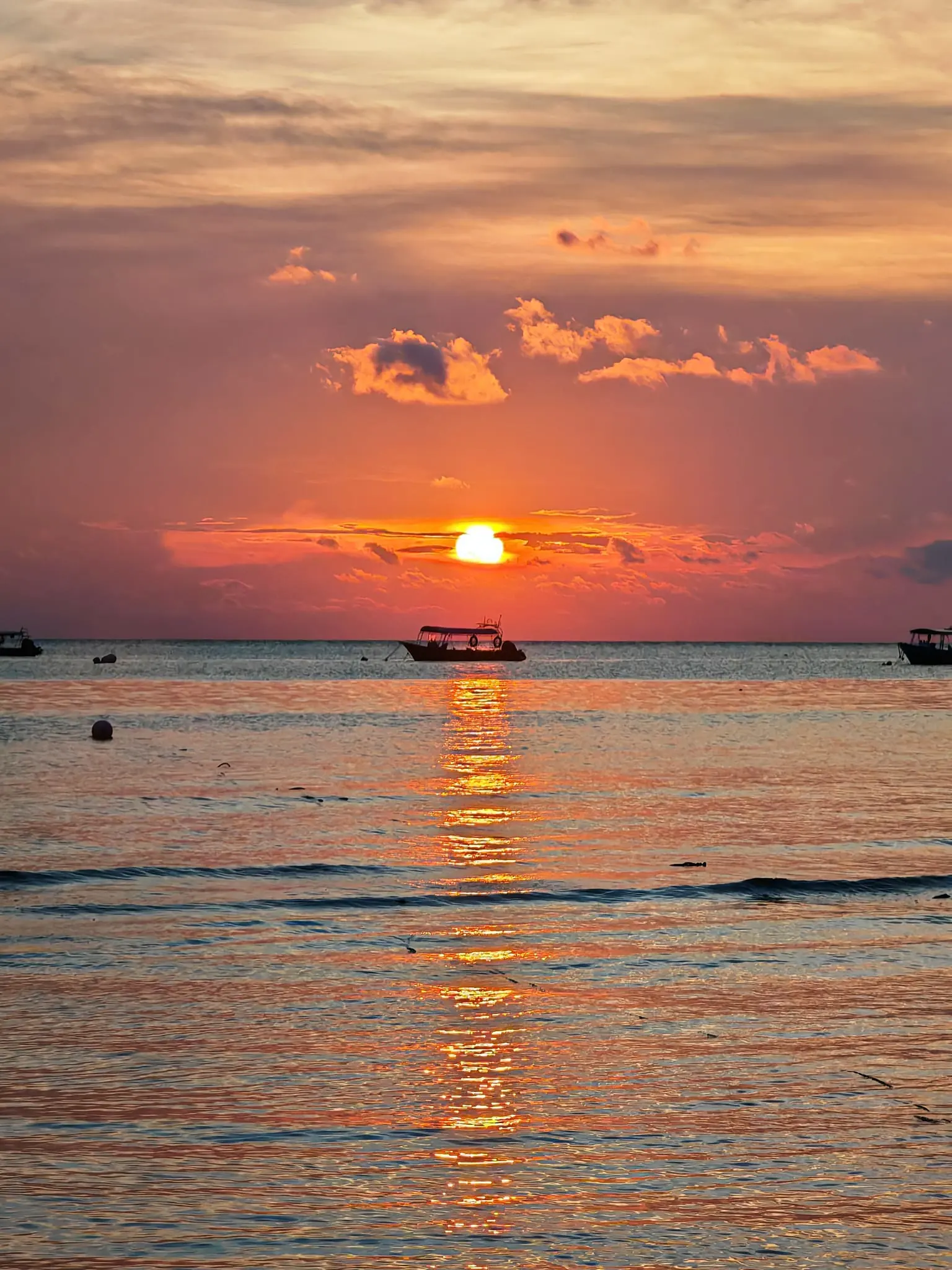 Enchanting Tioman Sea Sunset Long Sunrays Reflecting on the Water with a Boat Silhouette